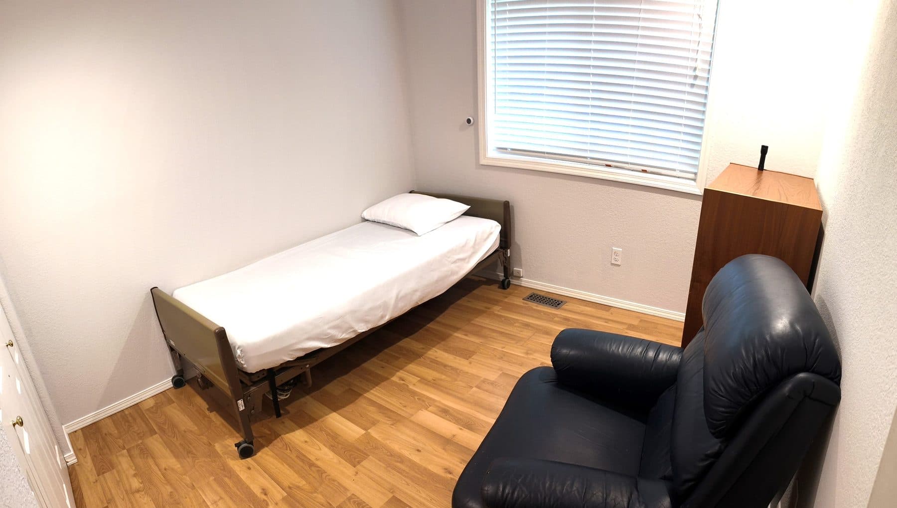 Private bedroom with a single bed, a bedside chest and a reclining armchair