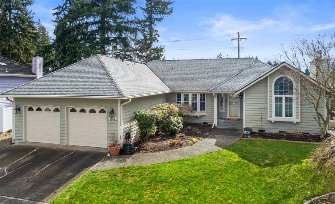 The front of Puyallup Bliss Adult Family Home — a single-storey house with a two-car garage and a landscaped lawn